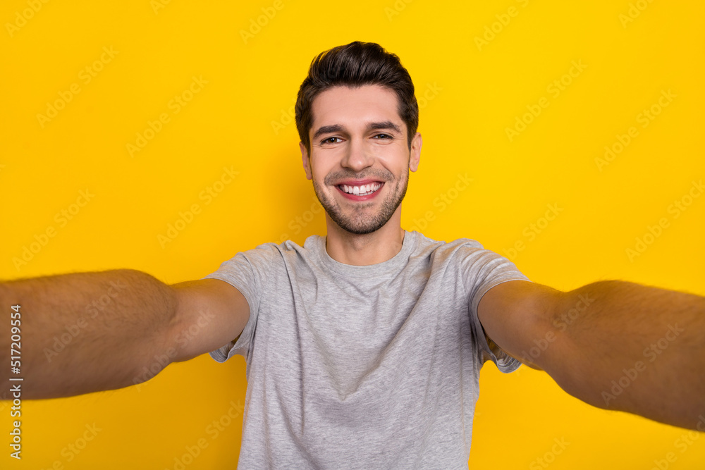 Sticker self-portrait of attractive cheerful guy wearing tsirt good mood isolated over bright yellow color b