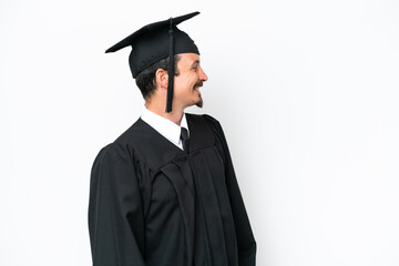 Young university graduate man isolated on white background in lateral position