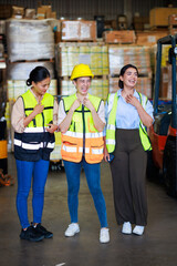 Group portrait Asian female warehouse worker checking order stock. Professional industrial warehouse team working at store workplace. Unity and teamwork concept.