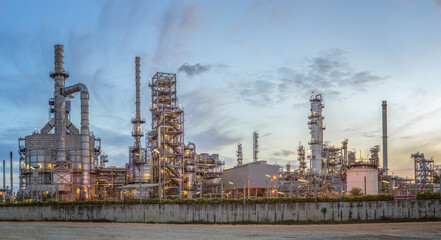 Fototapeta na wymiar Refinery from industrial area, Petrochemical oil and gas field view, oil refinery plant storage tank and steel pipes at sunset, ecology and environmental concepts
