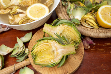 Cooking of green heads of artichokes plants, how to peel artichoke