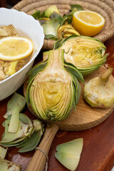 Cooking of green heads of artichokes plants, how to peel artichoke