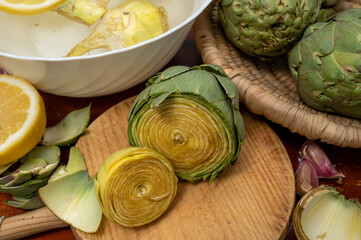 Cooking of green heads of artichokes plants, how to peel artichoke