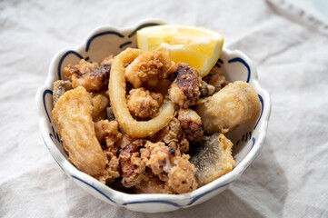 Spanish sea food, cripsy deep fried baby octopus, fish, calamari rings served with lemon