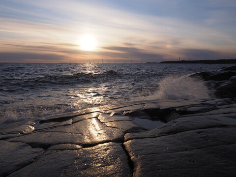 Sea waves and sunset at a rocky beach on Kallo Island Finland