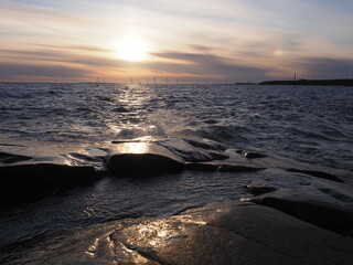 Fototapeta na wymiar Sunset at a rocky beach of Kallo Island 