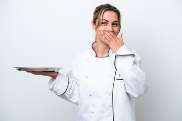 Young chef woman with tray isolated on white background happy and smiling covering mouth with hand