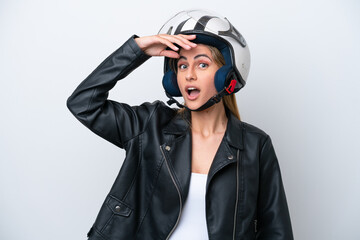 Young caucasian woman with a motorcycle helmet isolated on white background doing surprise gesture while looking to the side