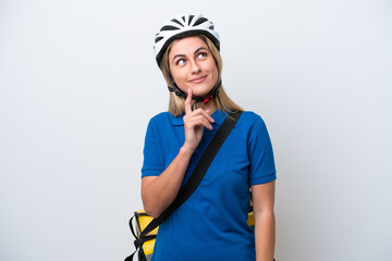 Young caucasian woman with thermal backpack isolated on white background thinking an idea while looking up