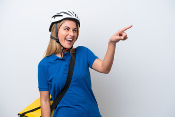 Young caucasian woman with thermal backpack isolated on white background pointing finger to the side and presenting a product
