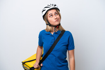 Young caucasian woman with thermal backpack isolated on white background and looking up