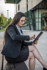 Business woman of the 21st century. A young girl works in the park. Flexible working hours.  Modern young girl.