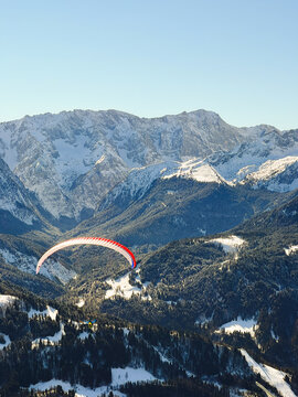 Paraglider flying over the valley in Garmisch in German Alps