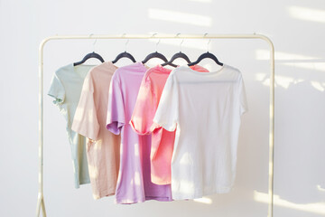 women's t-shirts on  hanger on  white background