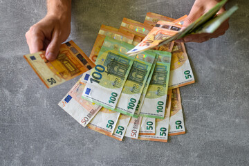 Euro banknotes in man's hand
