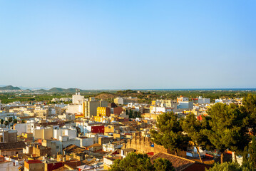 view from the hill to the old town surrounded by fields and mountains