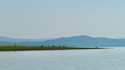 Lake at sunset. Wetland and Mountain landscape.