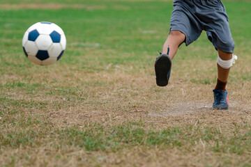 Obraz premium Football soccer children training class. Kindergarten school kids playing football in a field. Group of boys running and kicking soccer on sports grass pitch. Children in sportswear on football match.