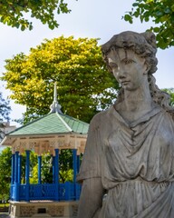 Blue gazebo and a lady statue in the middle of the park