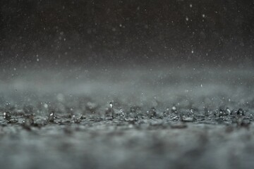 Close-up shot of rain drops on a water surface - obrazy, fototapety, plakaty