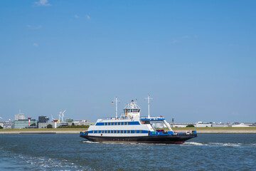 Fototapeta na wymiar View of a ferry on its way across the Weser to Bremerhaven/Germany