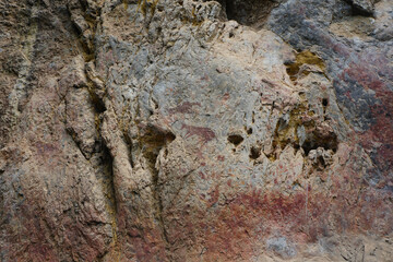 The Cliff of the Mountain Goat. Ancient wall paintings on limestone cliffs. Archaeological site of color paintings of Pratu Pha Camp of Lampang, Thailand.