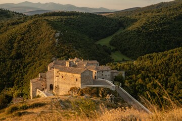 Scenic view of the San Severino Marche commune in green hills in Italy at golden hour