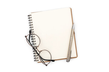 Notepad with pen and glasses on a white background. Top view.