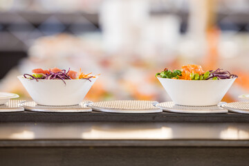 Two Poke-bowls on a sushi conveyor belt