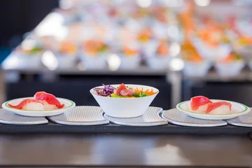 Fotobehang Poke-bowl with tuna and sushi on a sushi conveyor belt © Michiel