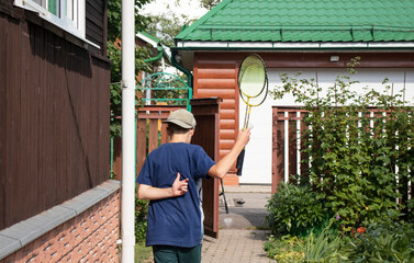 boy playing badminton in the summer in the village