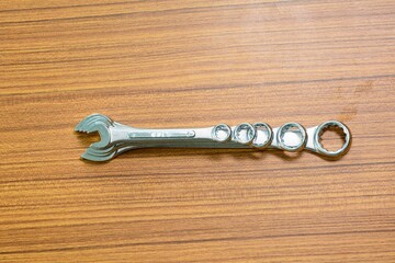 Wrench tools on a wood background