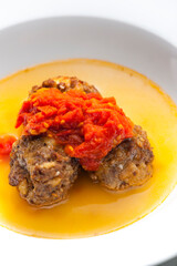 broth with meatballs and tomato sauce