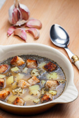 garlic soup with toasted bread and potatoes