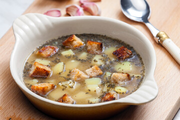 garlic soup with toasted bread and potatoes