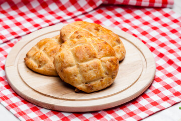 cracklings buns on wooden board