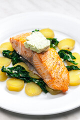 baked salmon with spinach leaves and potatoes