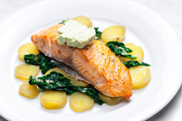 baked salmon with spinach leaves and potatoes