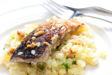 grilled carp with garlic served with mashed potatoes