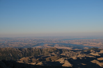 Perfect panoramic view at sunrise from Nemrut mountain. Blue sky and hills background.