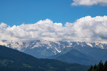 Beautiful  mountain landscape. High snow covered mountains in the fog .