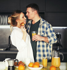 lifestyle and people concept - young beautiful couple having breakfast table