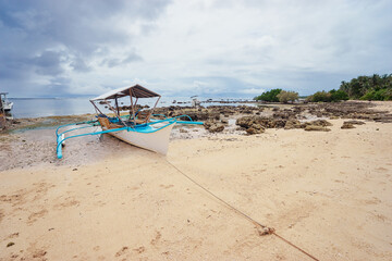 Beach with traditional fishing boat. Travel by Philippines.