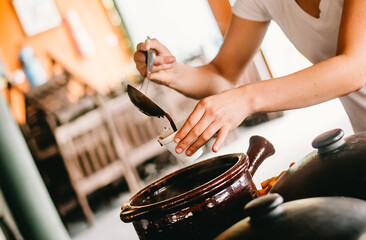 Feijoada broth being served in a glass at a restaurant's buffet in Brazil