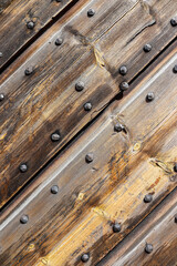 Weathered wooden panels with a lot of nails, part of an old fortress gate