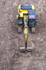 Construction site digger yellow during excavation on building site