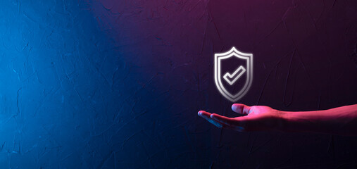 Male hand holding protect shield with a check mark icon on blue background. Protection network...