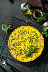 Сlassic quiche Lorraine pie with tuna, green beans and soft cheese. Crustless quiche with eggs, fish and vegetables. Mediterranean ketogenic healthy diet. View from above.