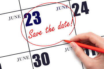 Hand drawing red line and writing the text Save the date on calendar date June 23.