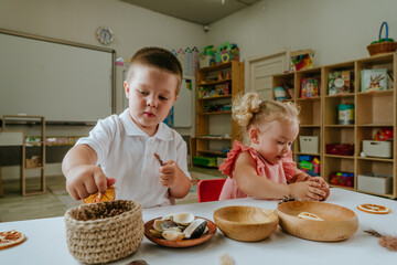 Children sorting using natural materials in kindergarten